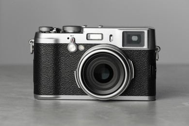 Vintage photo camera on grey marble table