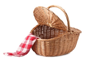 Photo of One open picnic wicker basket with checkered napkin isolated on white