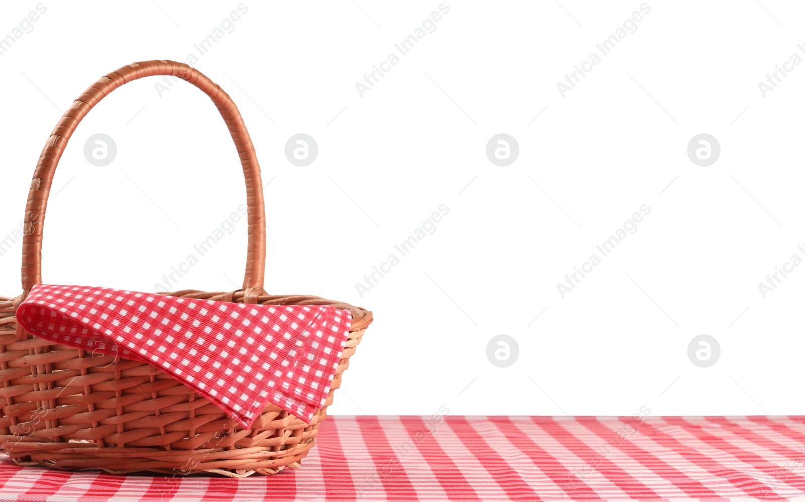 Photo of One picnic basket with napkin on table against white background. Space for text