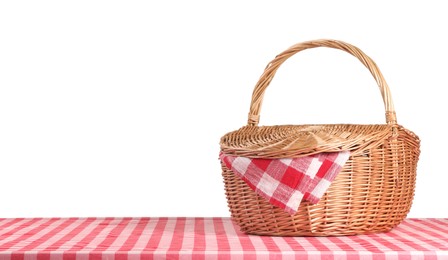 Photo of One picnic basket with napkin on table against white background. Space for text