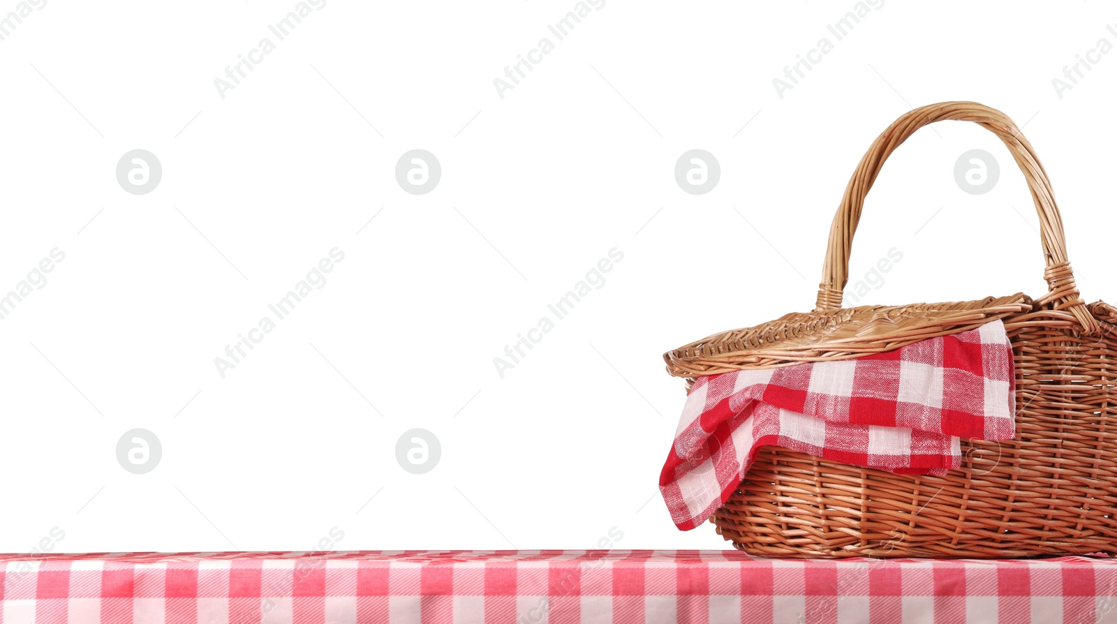 Photo of One picnic basket with napkin on table against white background. Space for text