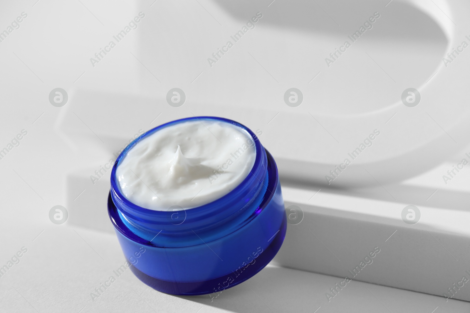 Photo of Stylish presentation of facial cream on white background, closeup