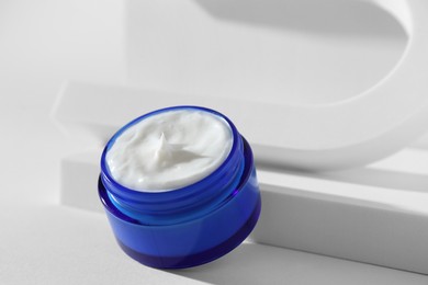 Stylish presentation of facial cream on white background, closeup