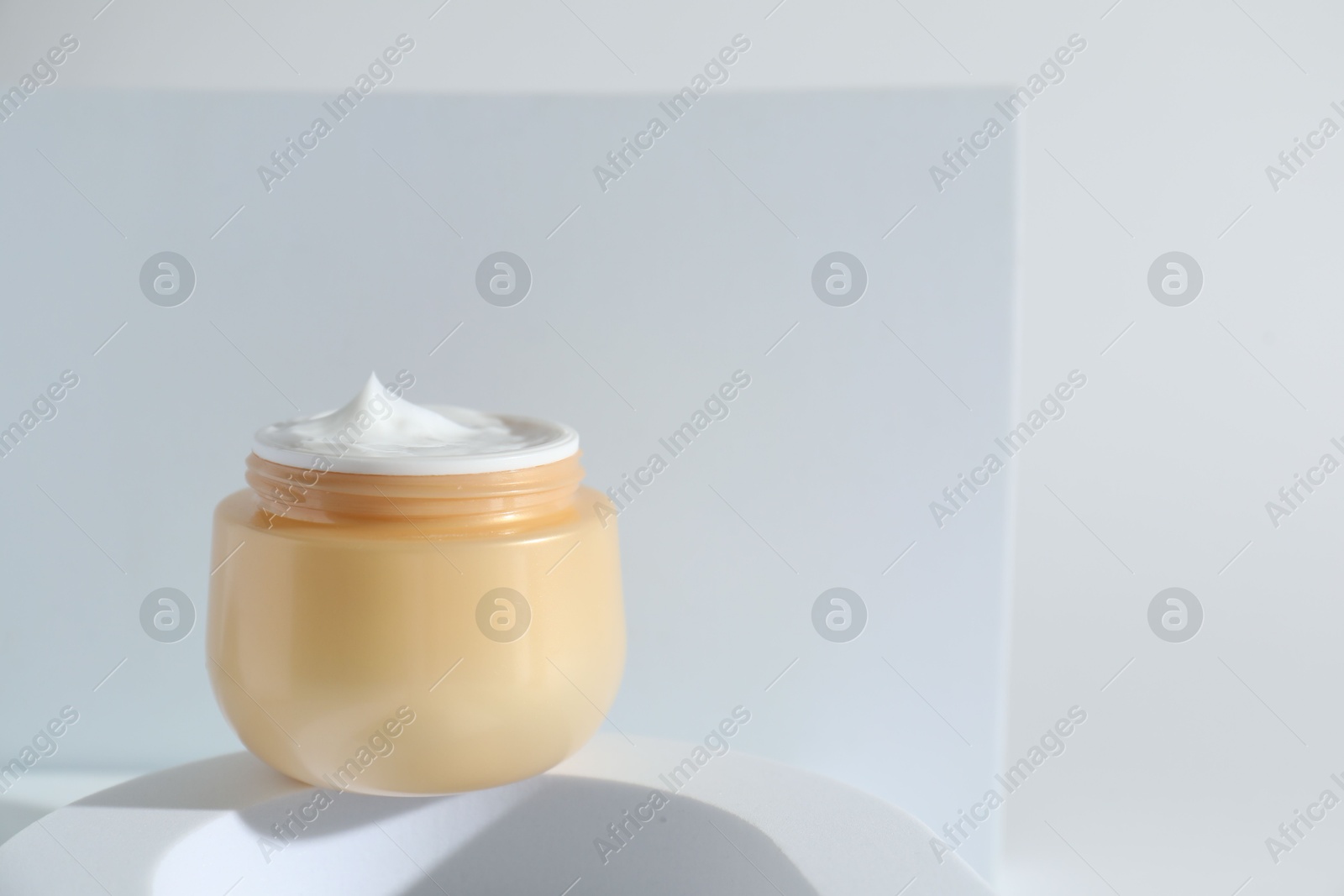 Photo of Stylish presentation of facial cream on white background, space for text