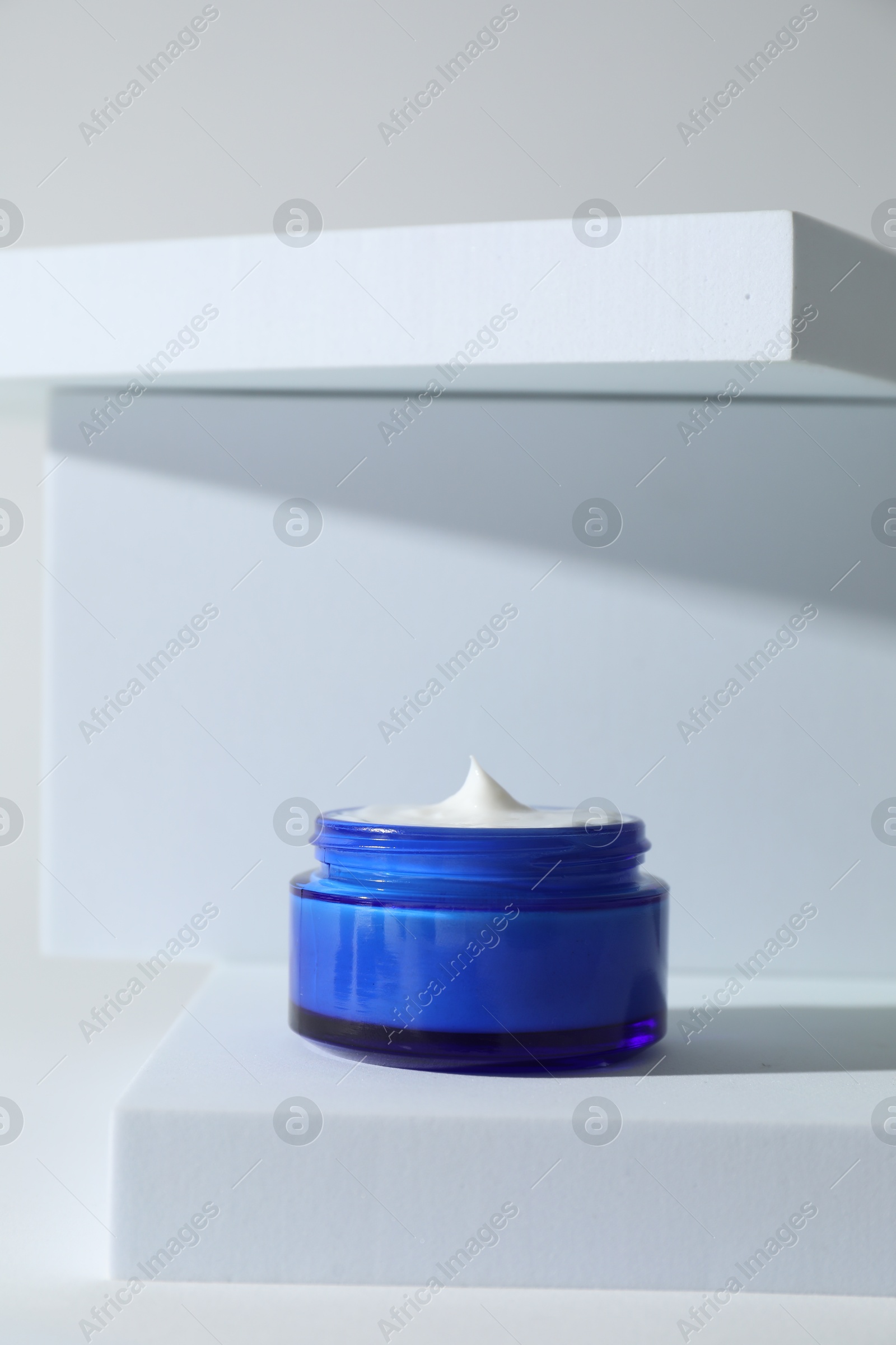 Photo of Stylish presentation of facial cream on white background