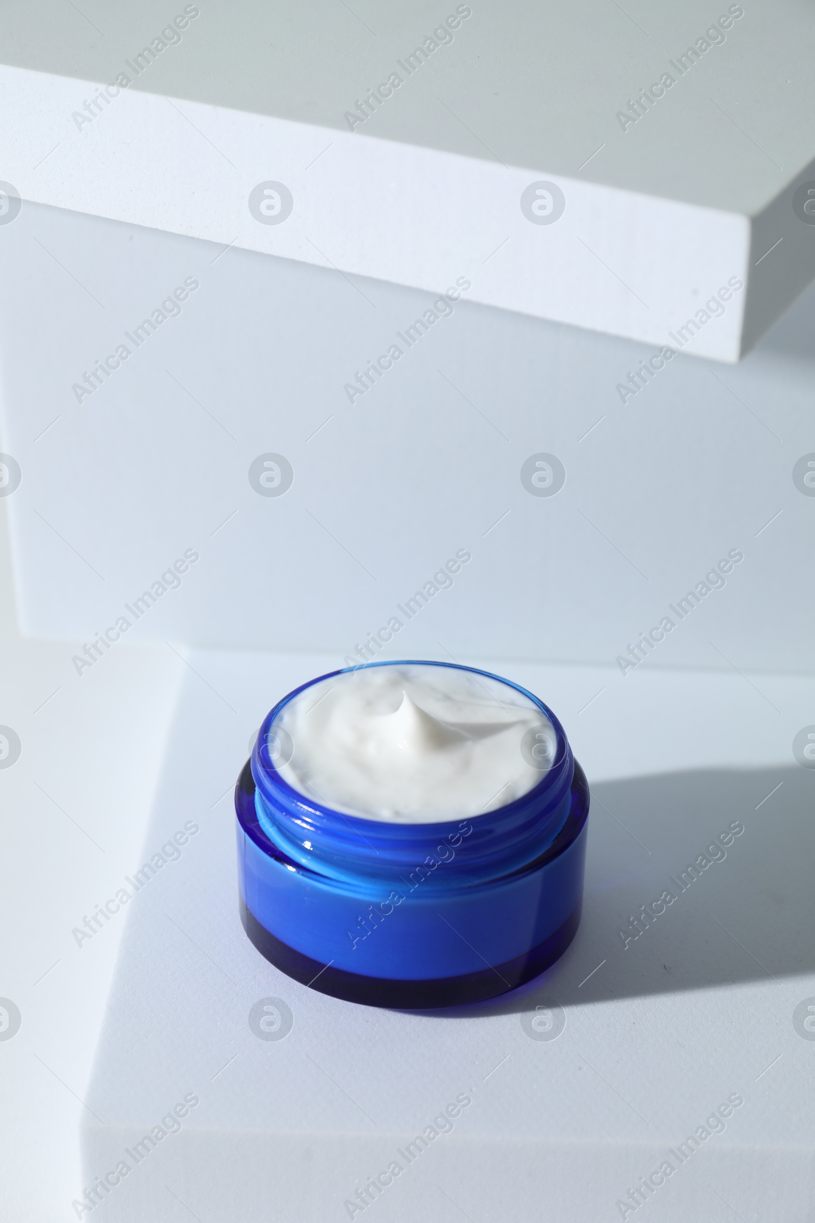 Photo of Stylish presentation of facial cream on white background