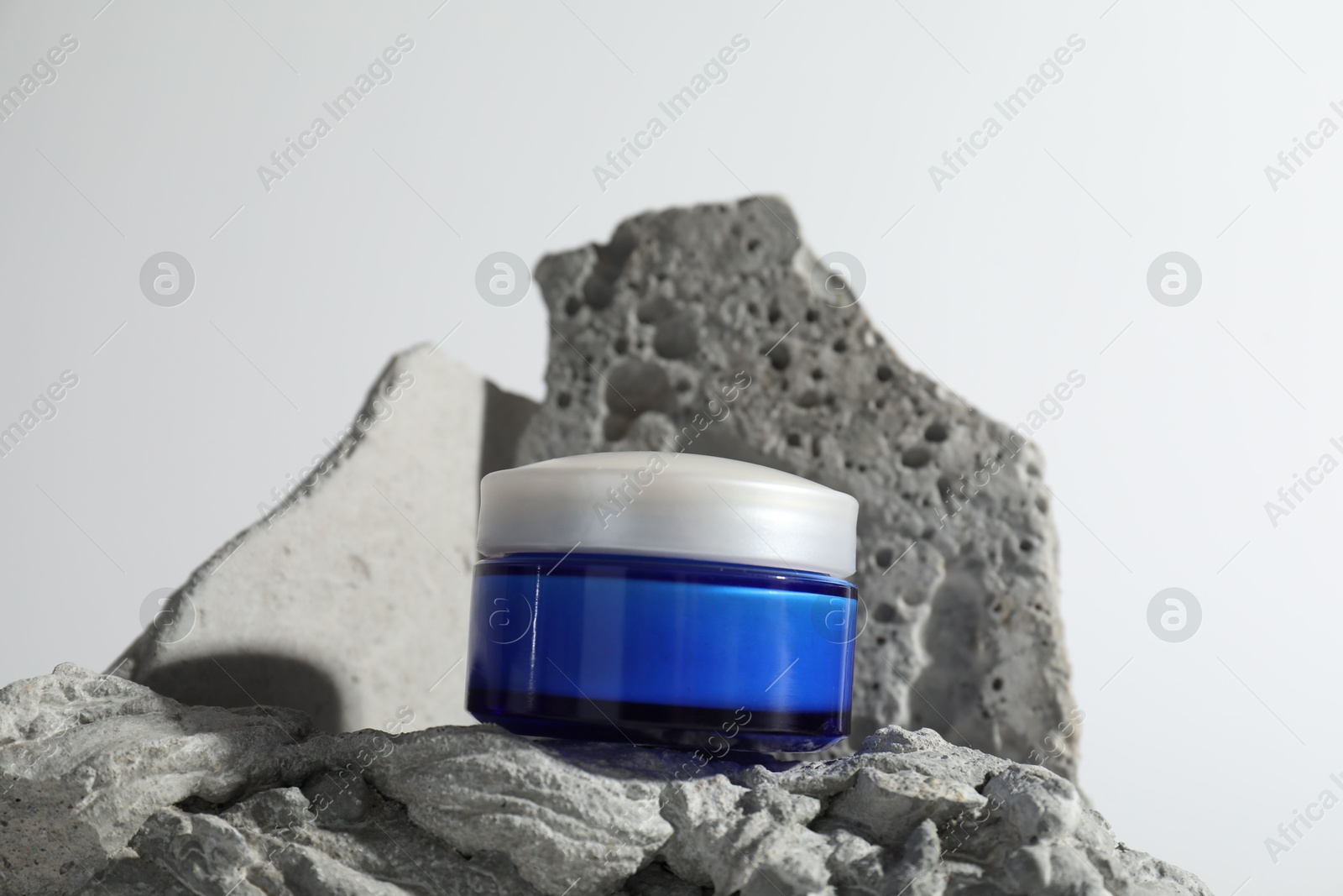 Photo of Stylish presentation of facial cream on white background, closeup