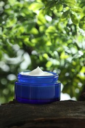 Photo of Stylish presentation of facial cream in jar outdoors