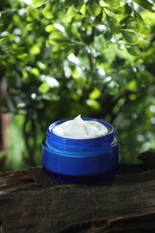 Stylish presentation of facial cream in jar outdoors