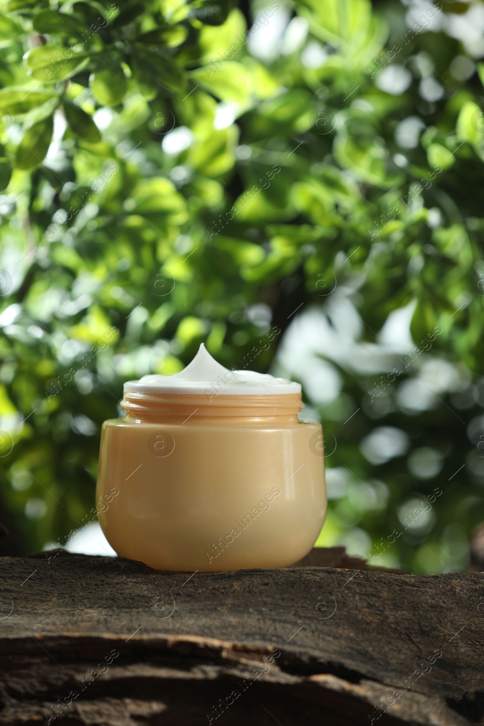 Photo of Stylish presentation of facial cream in jar outdoors