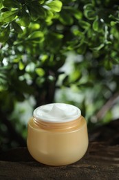 Stylish presentation of facial cream in jar outdoors