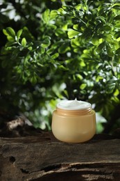 Stylish presentation of facial cream in jar outdoors