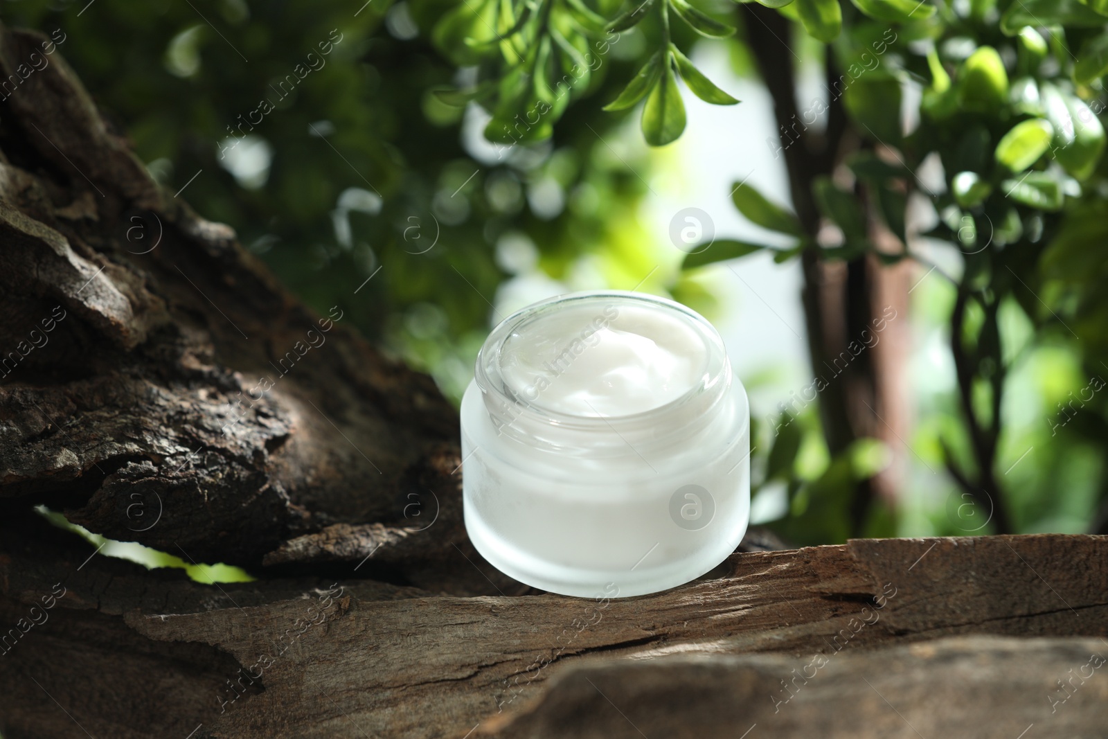 Photo of Stylish presentation of facial cream in jar outdoors