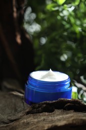 Stylish presentation of facial cream in jar outdoors, closeup