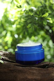 Stylish presentation of facial cream in jar outdoors, closeup