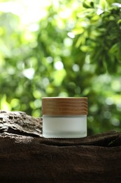 Stylish presentation of facial cream in jar outdoors