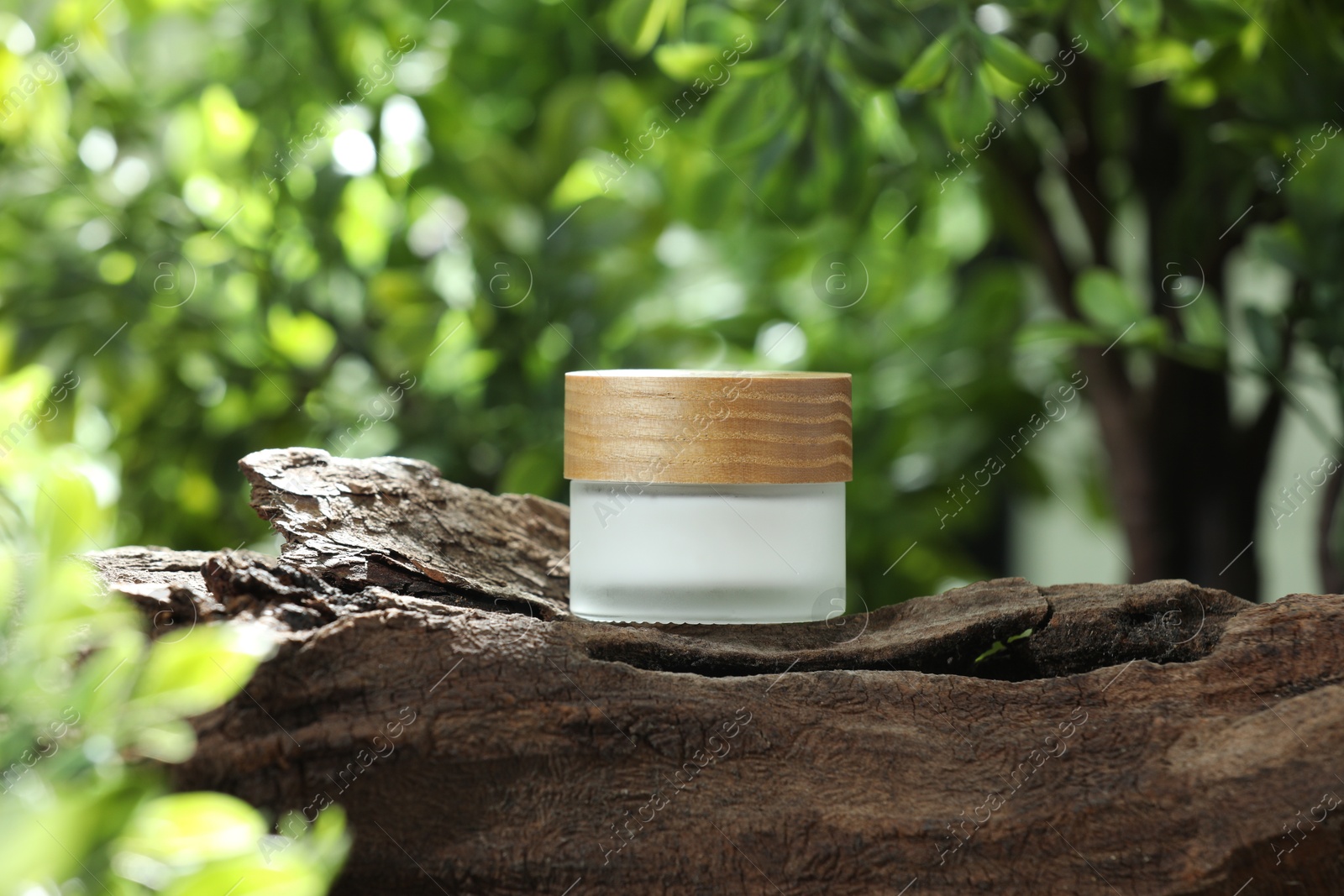 Photo of Stylish presentation of facial cream in jar outdoors