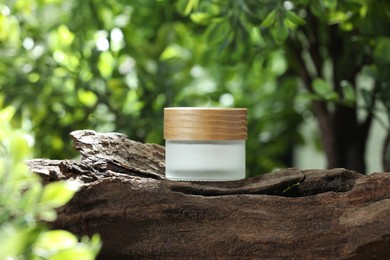 Stylish presentation of facial cream in jar outdoors