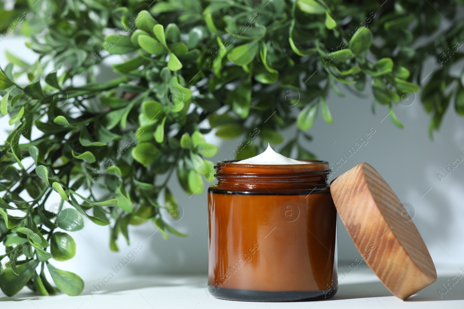 Photo of Stylish presentation of facial cream on white table