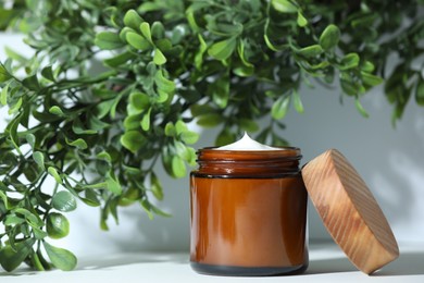 Stylish presentation of facial cream on white table