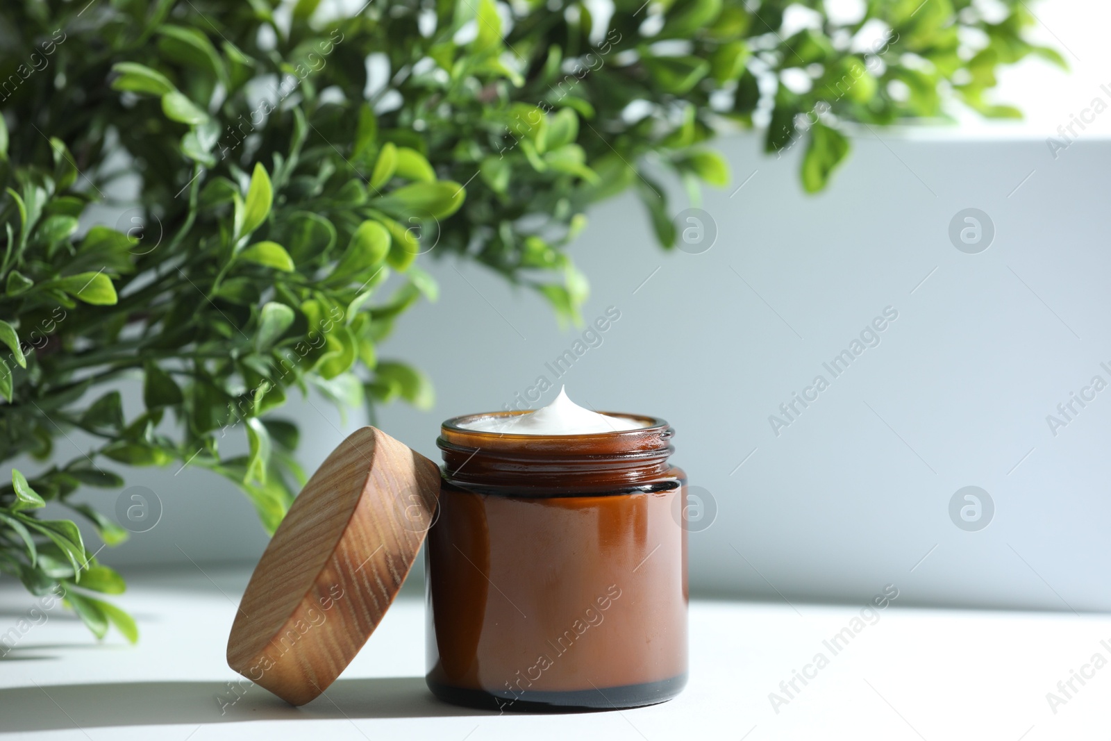 Photo of Stylish presentation of facial cream on white table