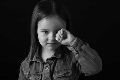 Photo of Portrait of sad girl on dark background, closeup. Black and white effect