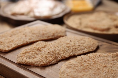 Making schnitzels. Raw meat and other ingredients on wooden table, closeup