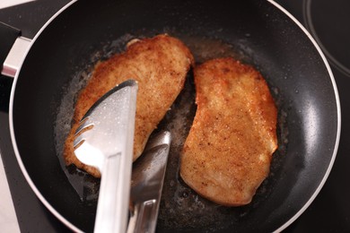 Photo of Schnitzels cooking in frying pan on stove, top view