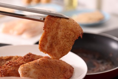 Photo of Cooking schnitzel in frying pan on stove, closeup