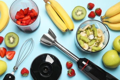 Photo of Hand blender kit, fresh fruits and strawberries on light blue background, flat lay