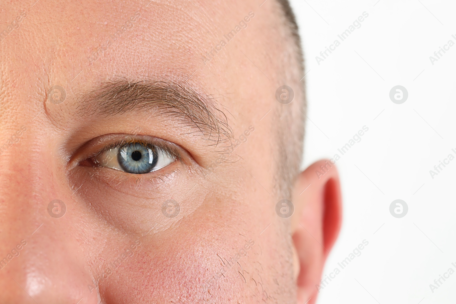 Photo of Man with beautiful blue eyes on white background, closeup