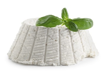 Photo of Tasty ricotta (cream cheese) and basil isolated on white