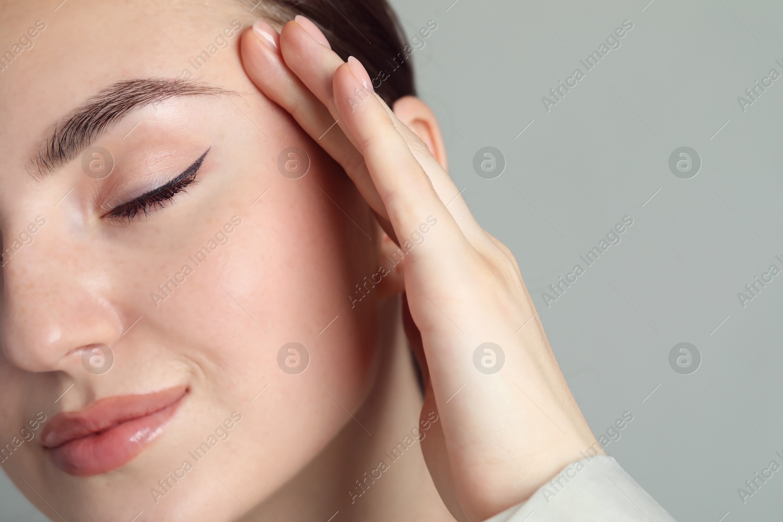 Photo of Young woman with beautiful eyebrow on light background, closeup and space for text