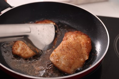 Photo of Schnitzels cooking in frying pan on stove, closeup