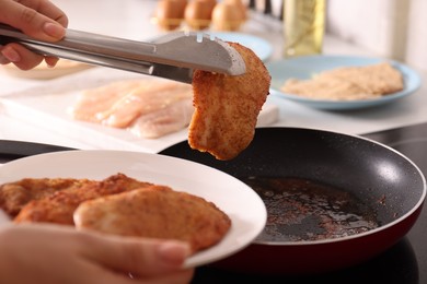 Photo of Woman cooking schnitzels in frying pan on stove, closeup