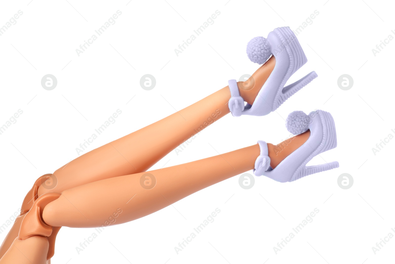 Image of Doll's legs with fancy shoes on white background