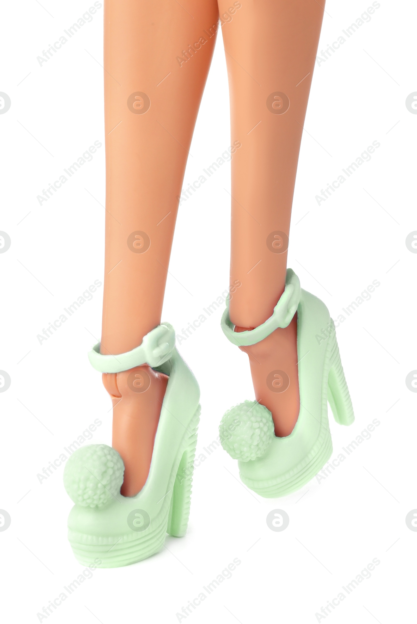 Image of Doll's legs with fancy shoes on white background