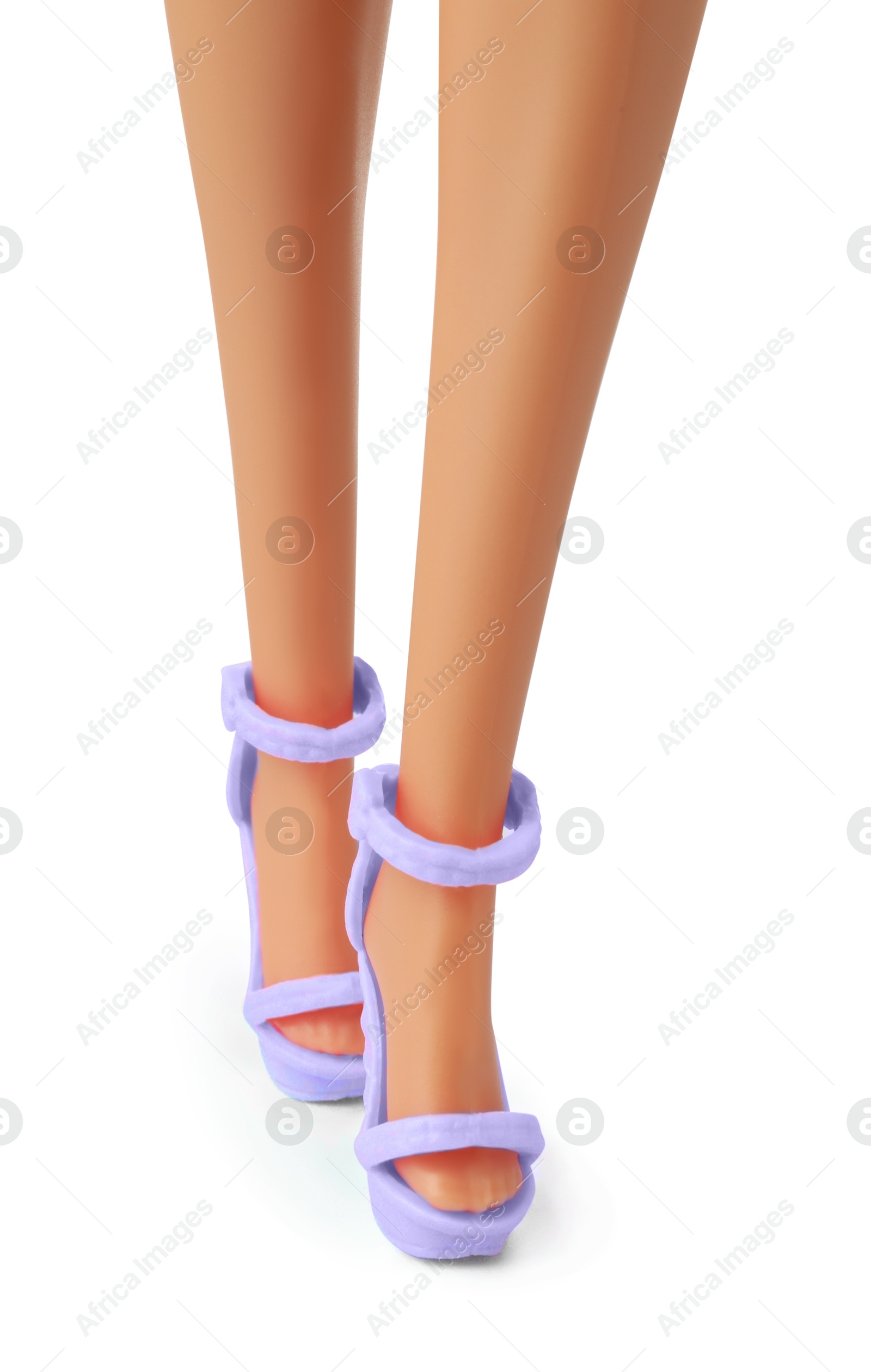 Image of Doll's legs with fancy shoes on white background