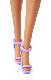 Image of Doll's legs with fancy shoes on white background