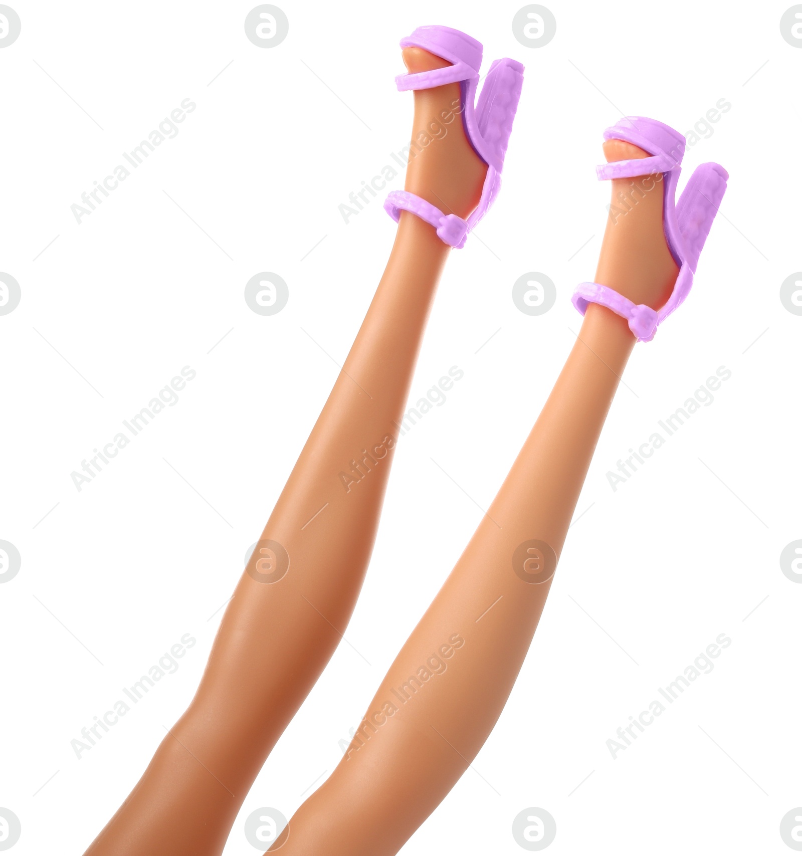 Image of Doll's legs with fancy shoes on white background