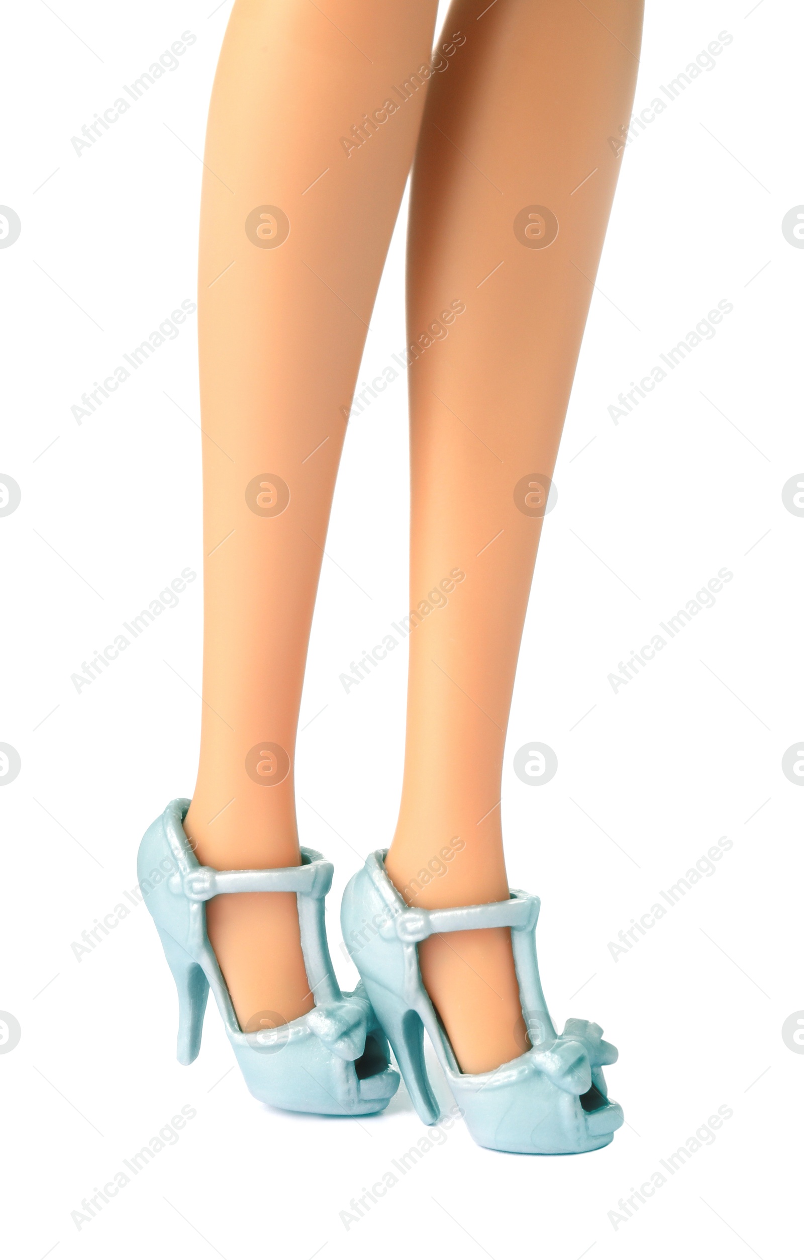 Image of Doll's legs with fancy shoes on white background