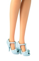 Image of Doll's legs with fancy shoes on white background