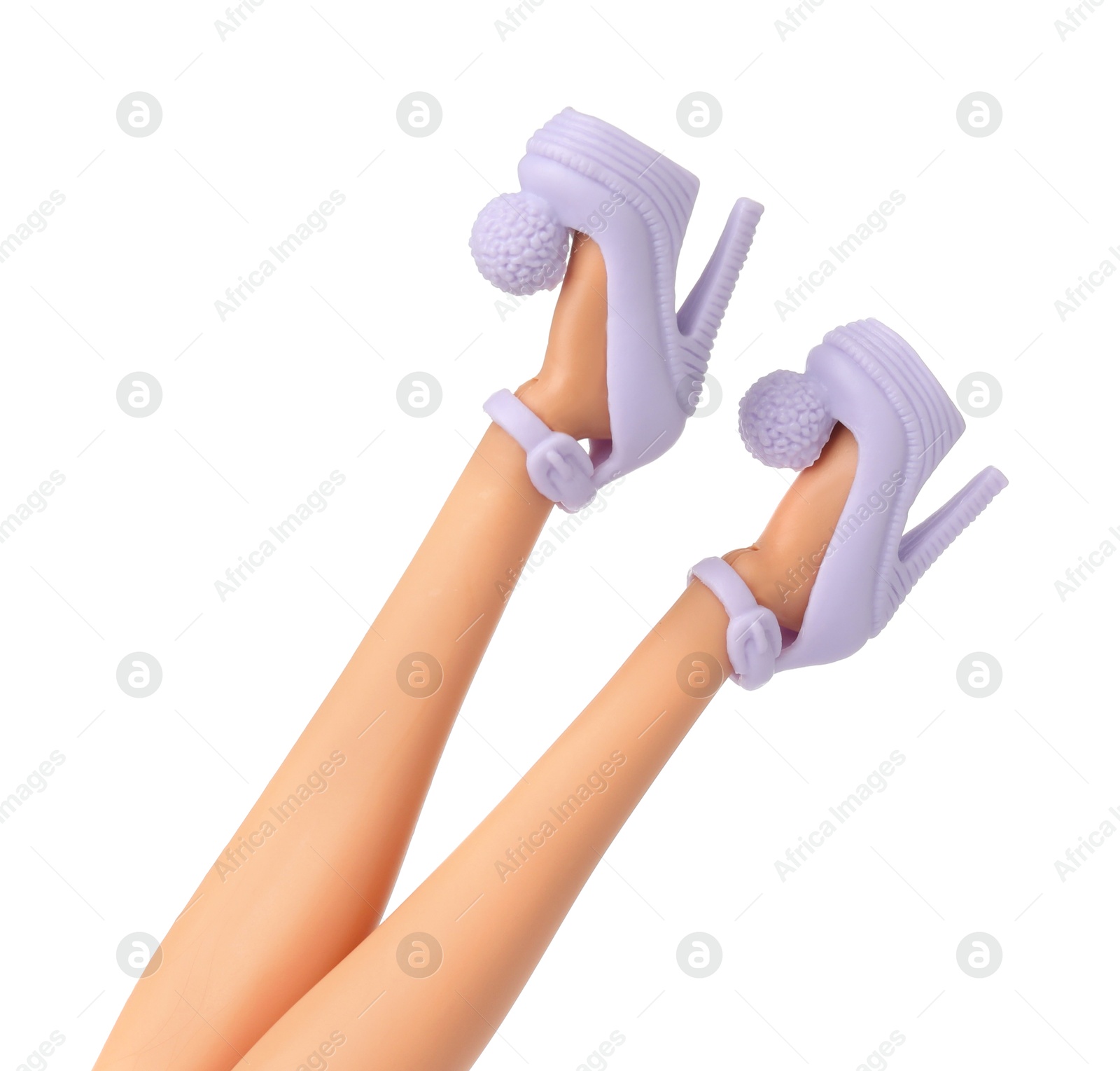 Image of Doll's legs with fancy shoes on white background