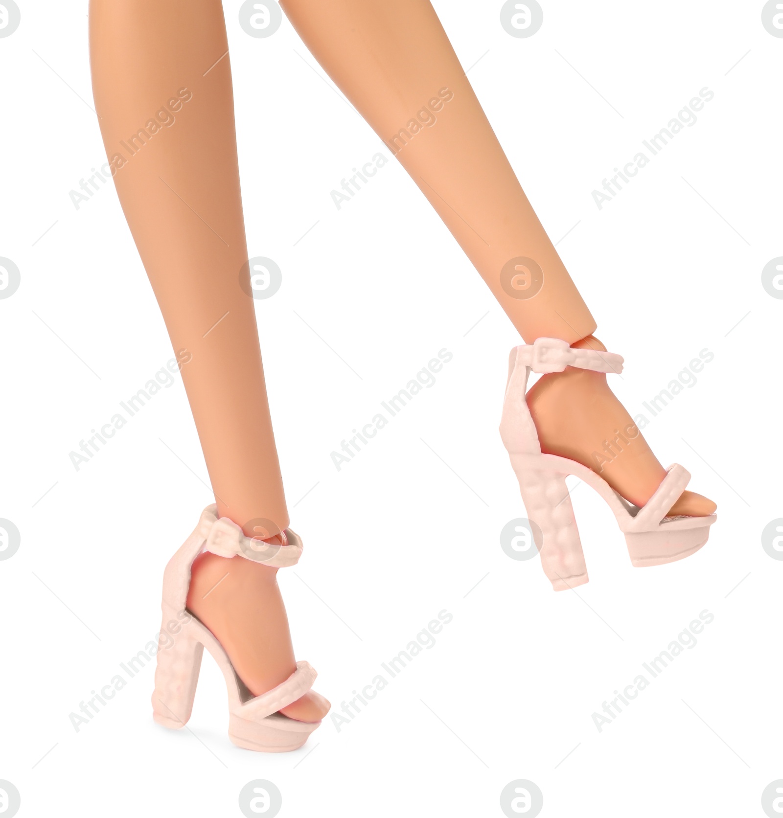 Image of Doll's legs with fancy shoes on white background