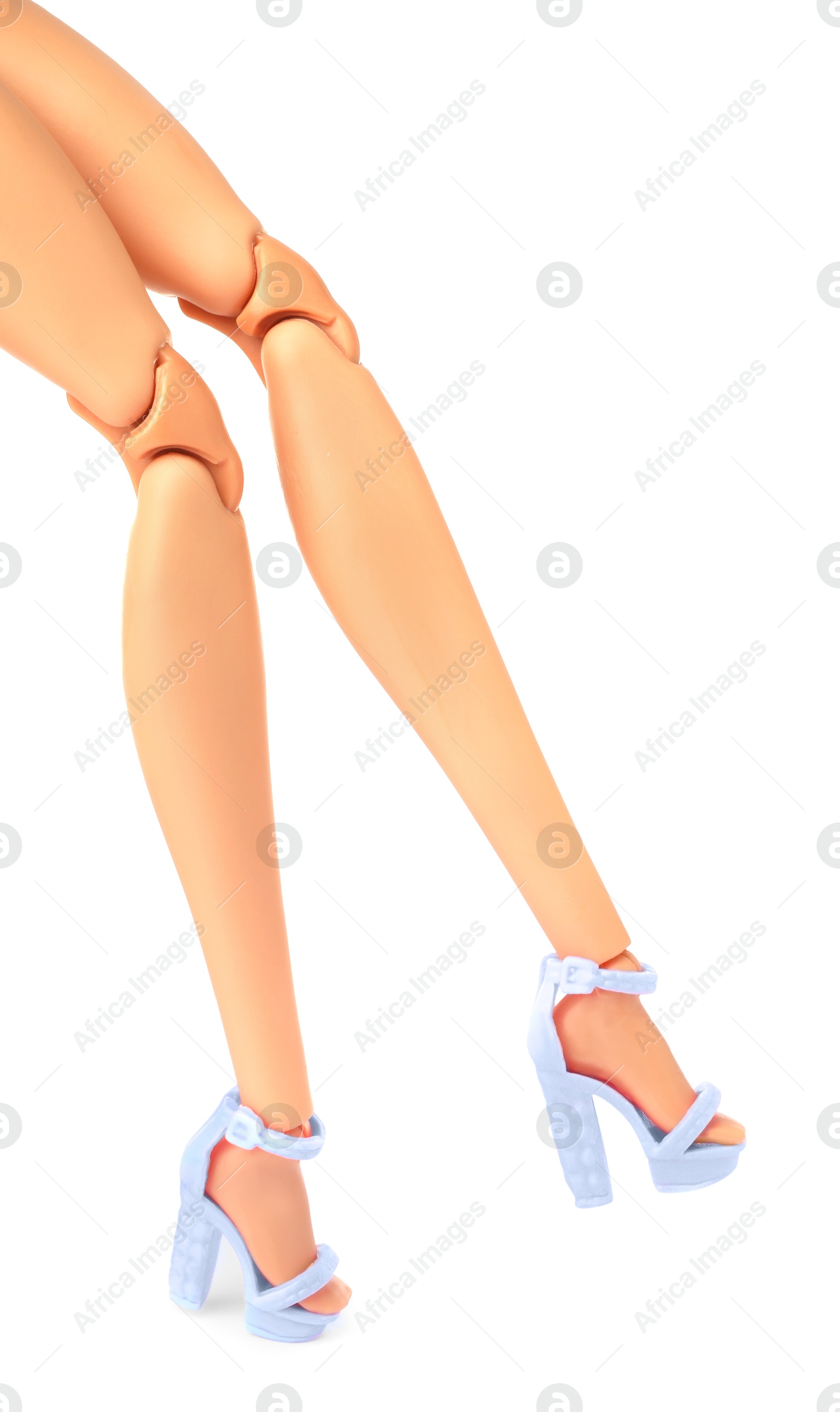 Image of Doll's legs with fancy shoes on white background