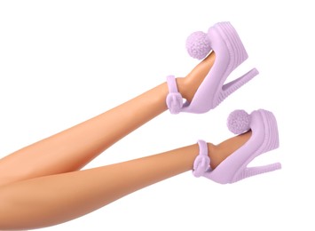 Image of Doll's legs with fancy shoes on white background