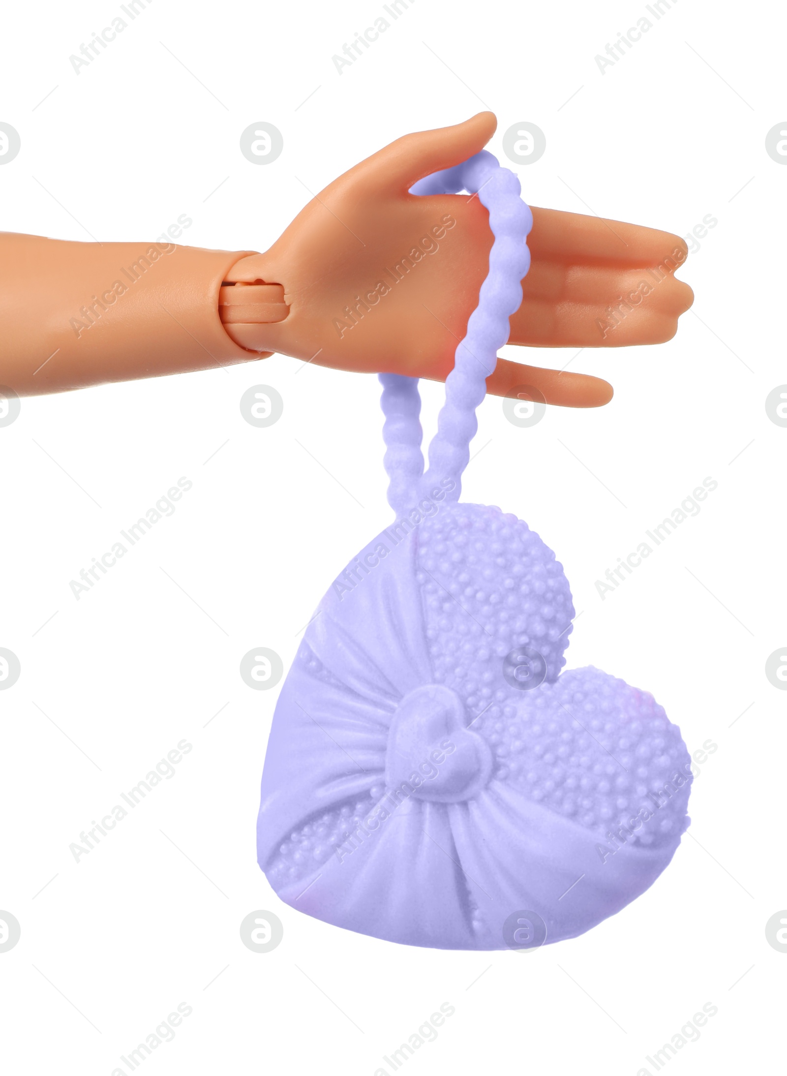 Image of Doll's hand with bag in shape of heart on white background