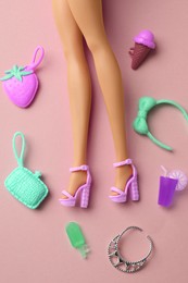 Image of Doll's legs with fancy shoes and different on beige pink background