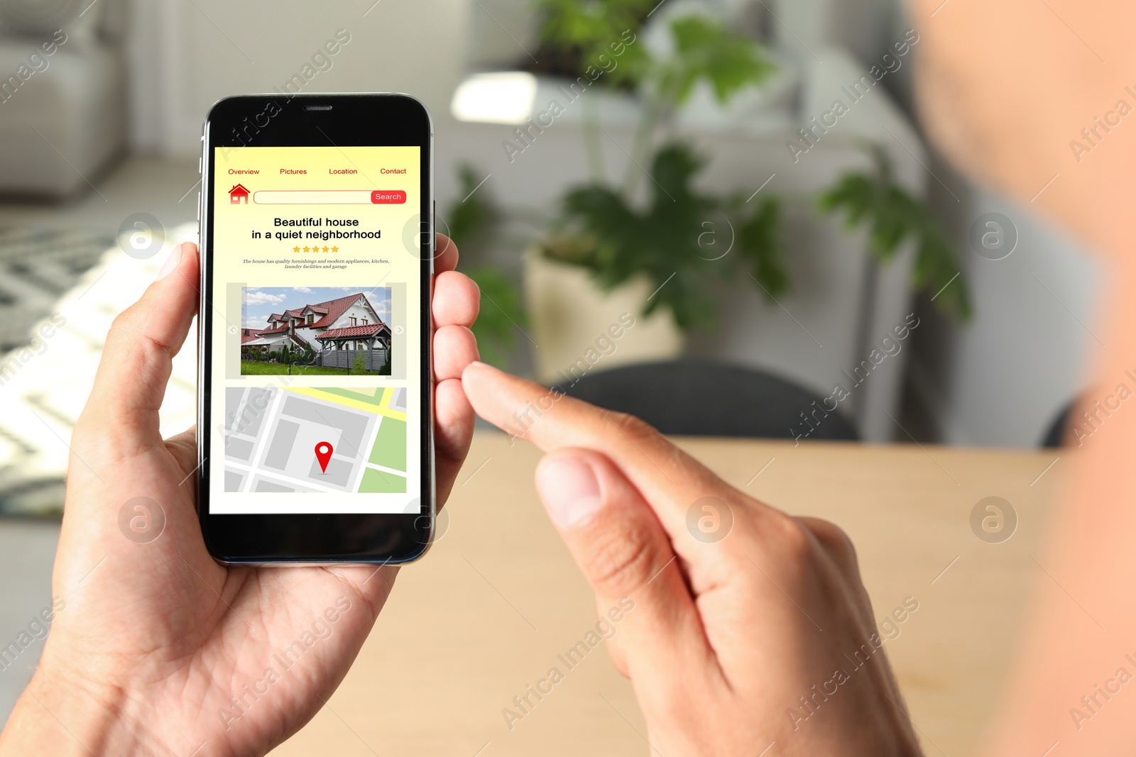 Image of Man choosing dwelling on house hunting website via smartphone indoors, closeup