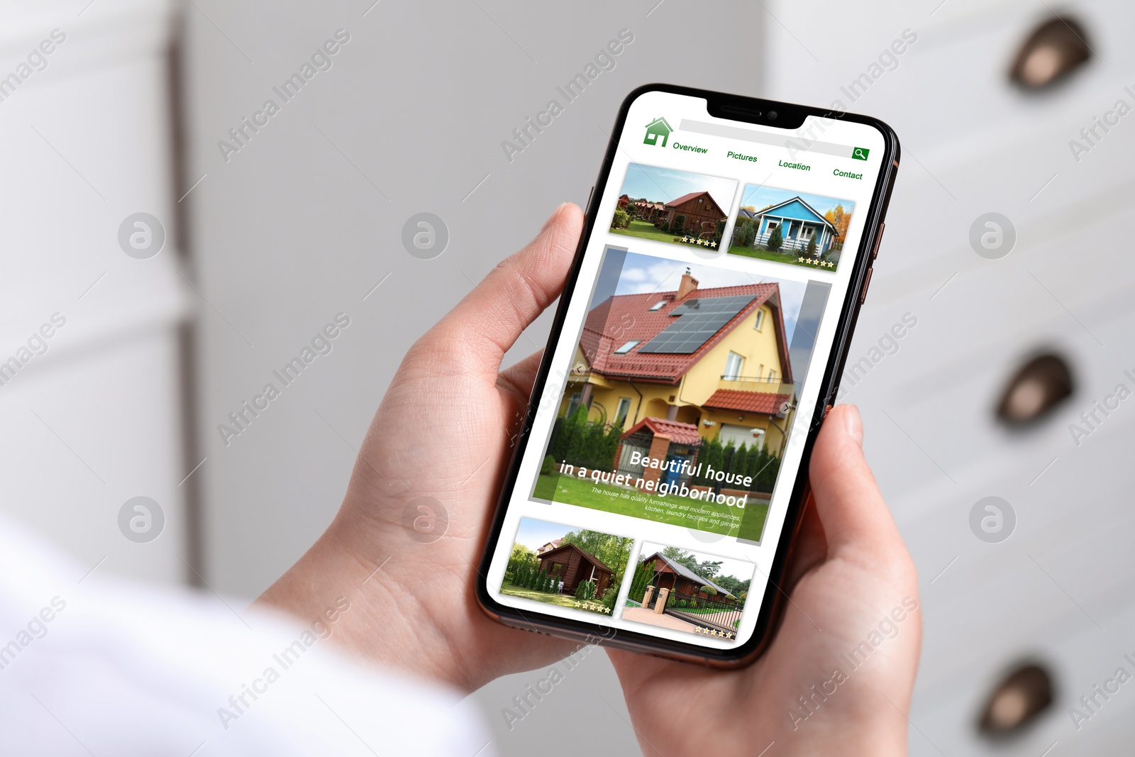 Image of Woman choosing dwelling on house hunting website via smartphone indoors, closeup